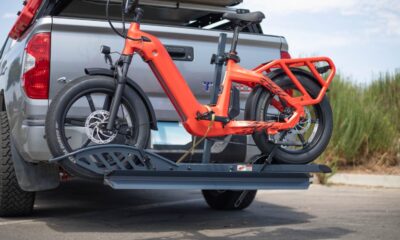 Two bikes mounted on a suspended hitch rack attached to a car