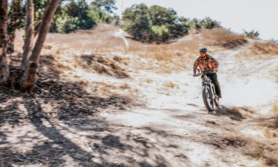 A fat tire electric bike equipped with an intelligent hybrid control system riding on a rugged trail.